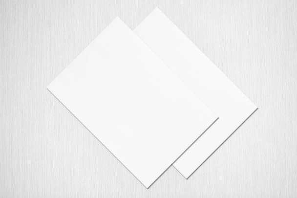 Two empty white poster mockups lying diagonally on grey concrete - Foto, Imagen