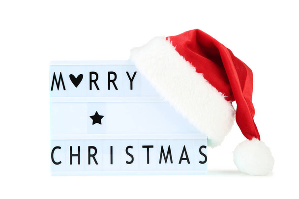 Lightbox with words Merry Christmas and red santa hat on white b - Φωτογραφία, εικόνα
