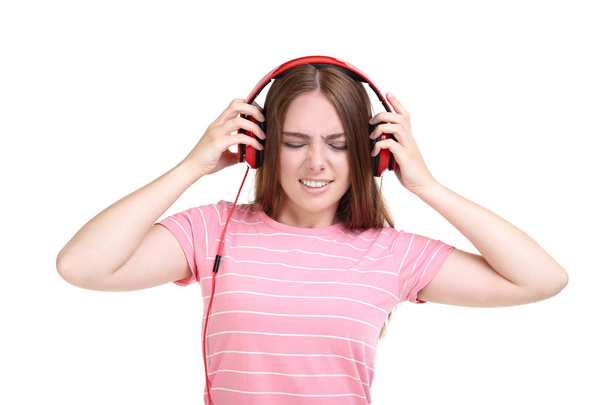 Young beautiful woman with headphones on white background - Photo, image