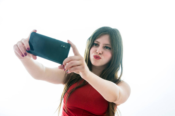 Portrait of teenage girl making a selfie - Foto, afbeelding