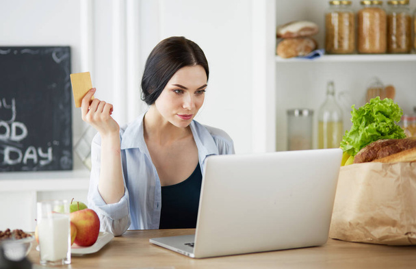 Young woman with her laptop at home - Photo, Image