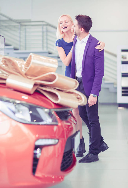 A man makes a gift - a car to his wife. She is surprised at this. They are very happy about - 写真・画像