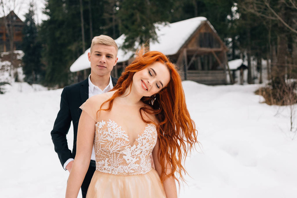 stylish couple, a young beautiful couple in the snow rejoices. . - Φωτογραφία, εικόνα