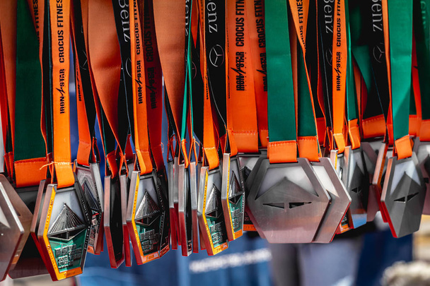 MOSCOW, RUSSIA - AUGUST 25, 2019: Medals for rewarding participants after the triathlon on IRONSTAR CROCUS FITNESS TRIATHLON 2019. - Foto, imagen