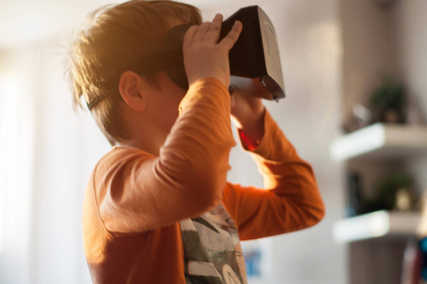 boy playes with modern virtual reality glasses - Foto, Imagem