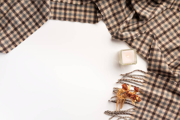 Warm scarf and candle, isolated on white background. Flat lay. - Φωτογραφία, εικόνα