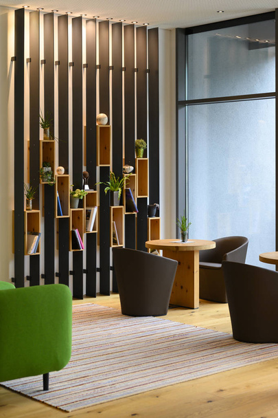 vertical metal shelf plant and book decoration on wooden boards boxes in indoor lobby - Photo, Image
