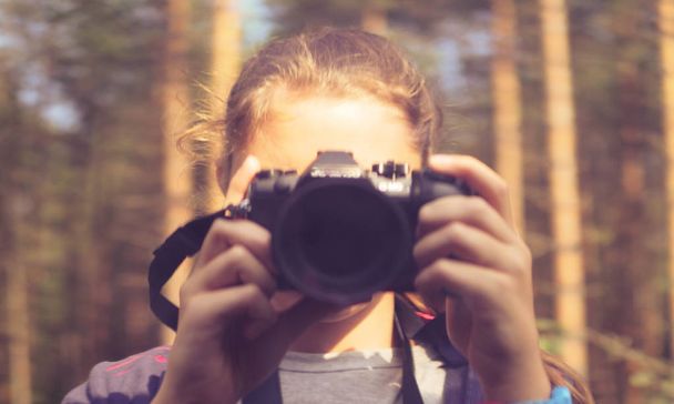 shot of a girl holding a camera. - Фото, зображення