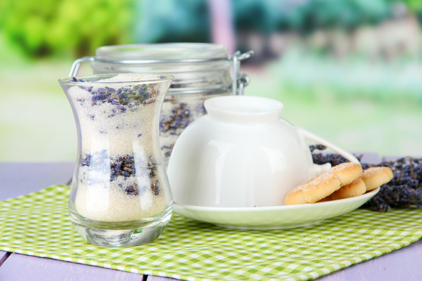Jar of lavender sugar and fresh lavender flowers on bright background - Photo, image