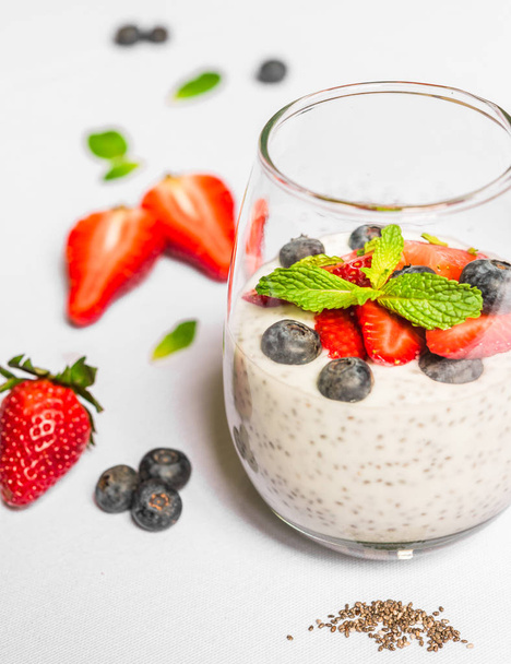 Breakfast yoghurt with chia seeds against white background.  - Foto, imagen