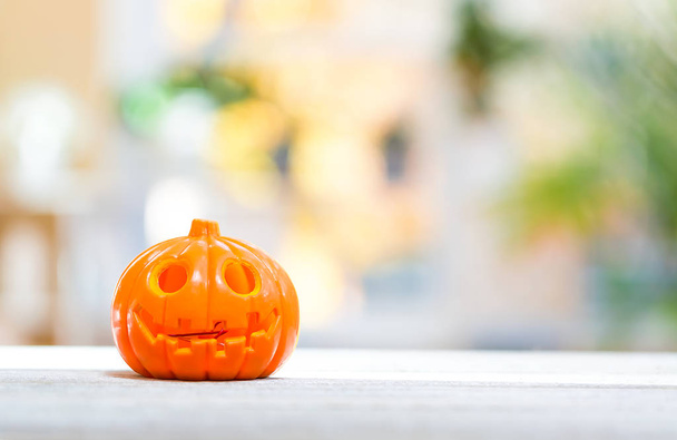 Little pumpkin on a bright interior background - Photo, Image