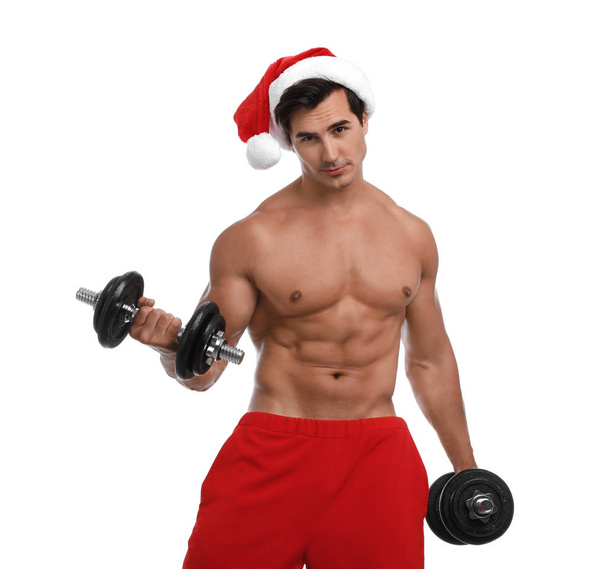 Sexy shirtless Santa Claus with dumbbells on white background - Фото, изображение