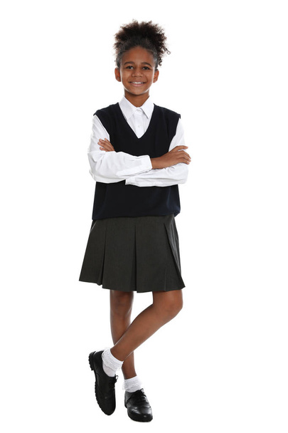 Happy African-American girl in school uniform on white background - Фото, изображение