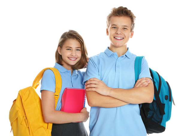 Happy pupils in school uniform on white background - Фото, изображение