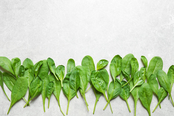 Fresh green healthy spinach on light table, flat lay. Space for text - Fotó, kép