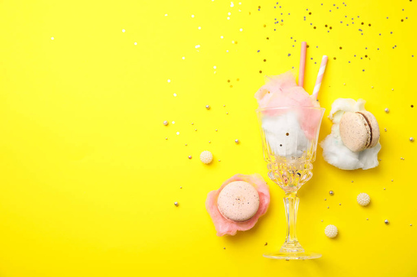 Flat lay composition with sweet cotton candy on yellow background, space for text - Fotoğraf, Görsel