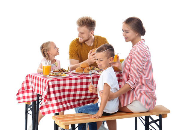 Happy family having picnic at table on white background - Valokuva, kuva