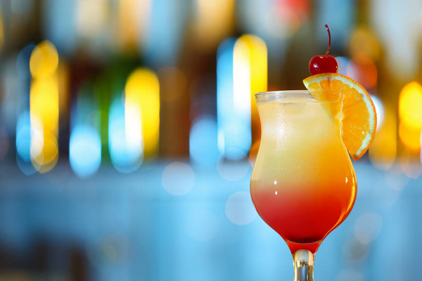 Glass of fresh alcoholic cocktail against blurred background. Space for text - Photo, image
