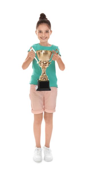 Happy girl with golden winning cup isolated on white - Fotó, kép