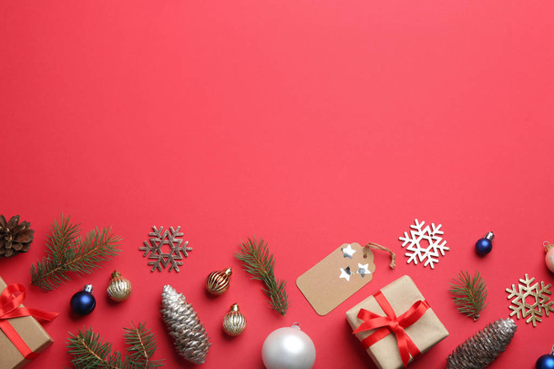 Flat lay composition with Christmas decor on red background. Space for text - Valokuva, kuva