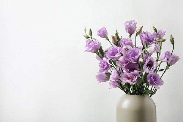 Eustoma flowers in vase on white background, space for text - Photo, image