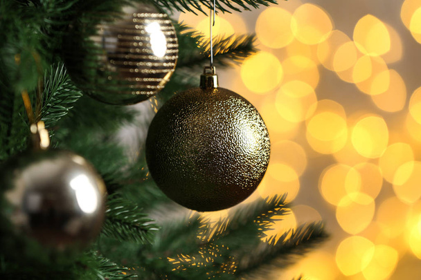 Decorated Christmas tree against blurred lights on background. Bokeh effect - Foto, imagen