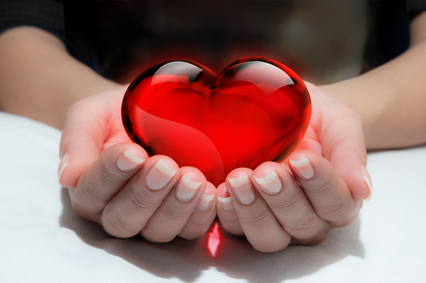 Glass heart in the heart hand - Photo, Image