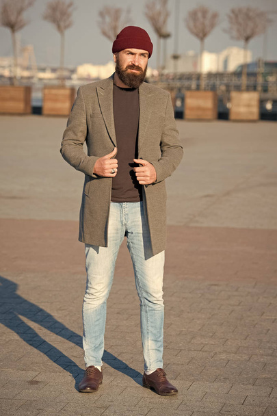 Stylish casual outfit for fall and winter season. Menswear and male fashion concept. Man bearded hipster stylish fashionable coat and hat. Stylish modern outfit hat bright accessory. Hipster outfit - Φωτογραφία, εικόνα