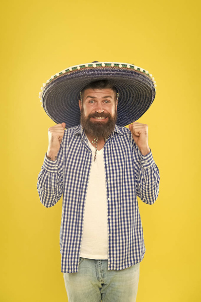His giant sombrero is perfect. Traditional fashion accessory for costume party. Mexican man wearing sombrero. Bearded man in mexican hat. Hipster in wide brim hat. He is in love with mexican style - Photo, image