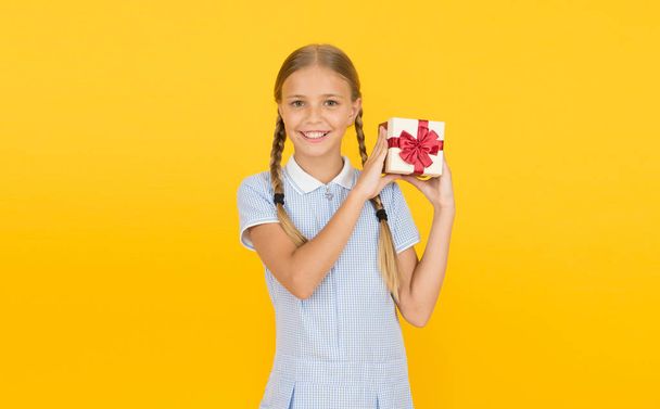 Generosity concept. Holiday celebration. Girl received gift. Tidy adorable pupil open gift box. Educational program for gifted kids. Happy birthday. Knowledge day. Schoolgirl giving gift to you - Foto, imagen