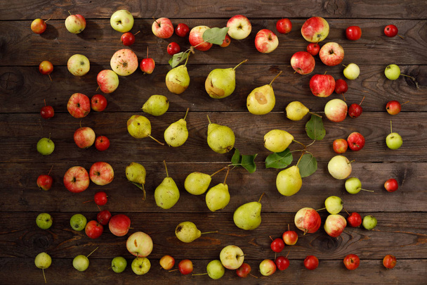 Colorful frame a fruit pattern of fresh red autumnal apples on a wooden background. - Photo, image