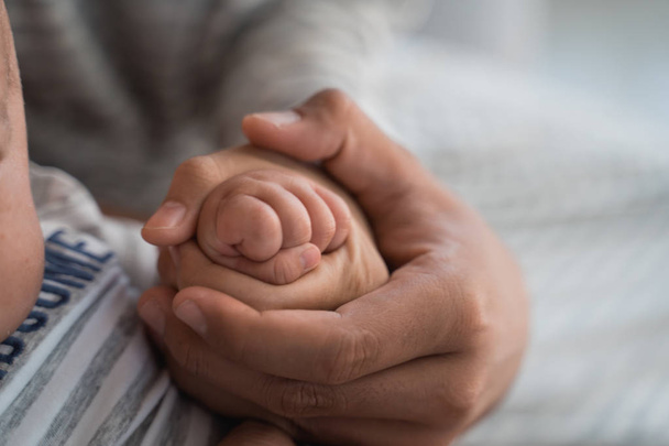 Babys finger with parent together hold hand
 - Фото, изображение