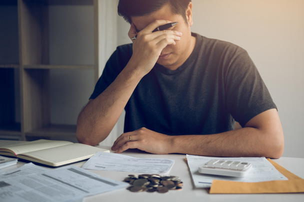 Asian men are stressed about financial problems, with invoices a - Photo, image
