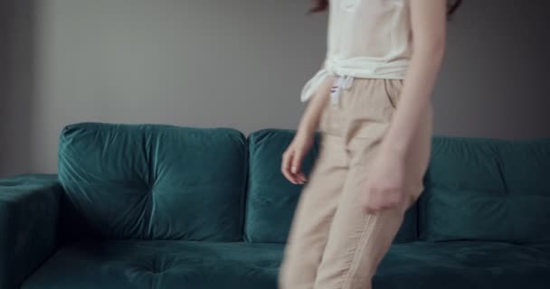 Redhead tired woman falling on sofa at home with a headache. - Filmmaterial, Video