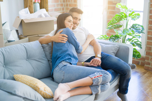 Beautiful couple hugging in love at the sofa, very happy smiling - Photo, image