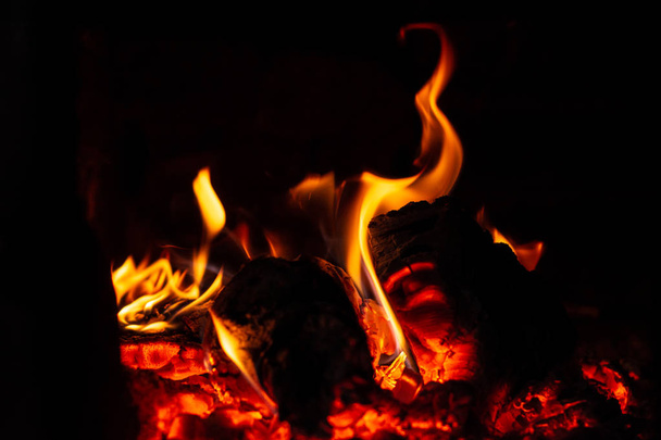 The fire burns and the wood in the stove actively burns. - Fotó, kép