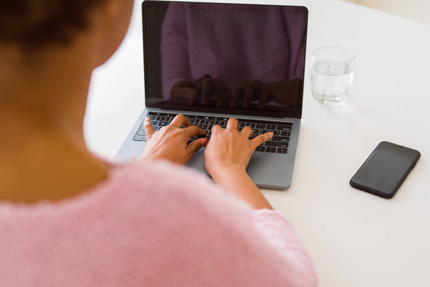 Крупним планом молода жінка працює друкуючи за допомогою ноутбука
  - Фото, зображення
