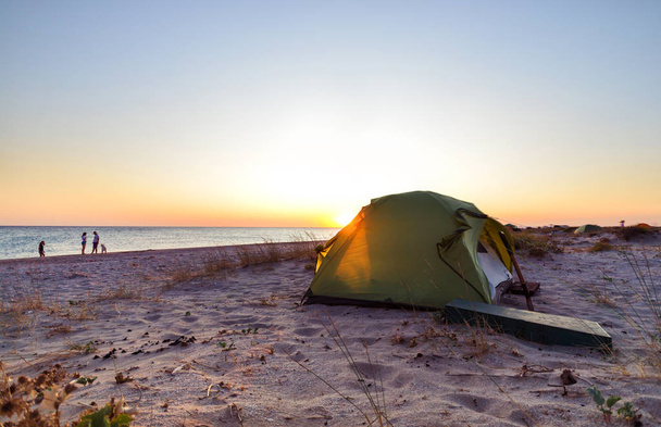 Tent on a beach on a sunset background - Foto, imagen