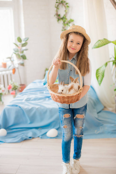 Cute girl with easter bunnies in the room decorative for the holiday. Easter mood - Foto, immagini