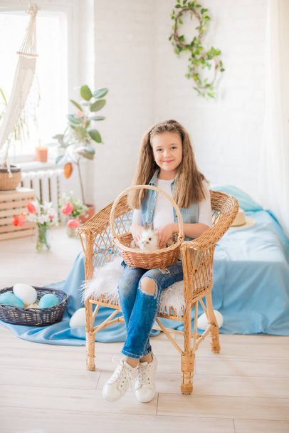 Cute girl with easter bunnies in the room decorative for the holiday. Easter mood - Foto, Bild