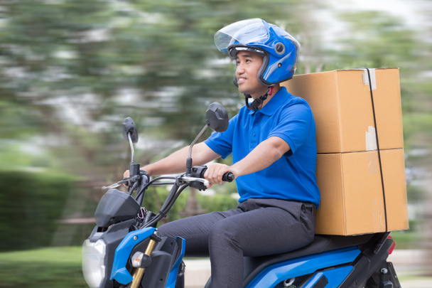 Courier delivering parcel box by motorcycle or scooter. Fast express transport delivery concept - Foto, afbeelding