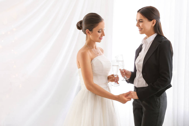 Düğün töreni sırasında şampanya bardak ile güzel lezbiyen çift - Fotoğraf, Görsel