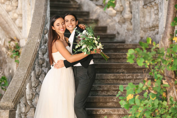 Beautiful lesbian couple on their wedding day outdoors - Photo, image