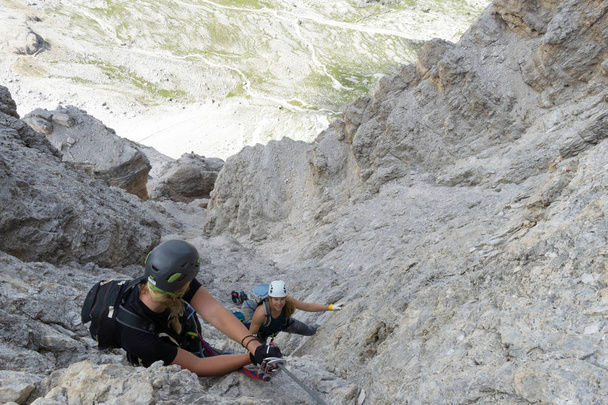 attractive female climbers on a steep Via Ferrata in the Italian - Photo, Image