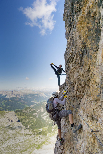 attractive female climbers on a steep Via Ferrata in the Italian - Photo, Image