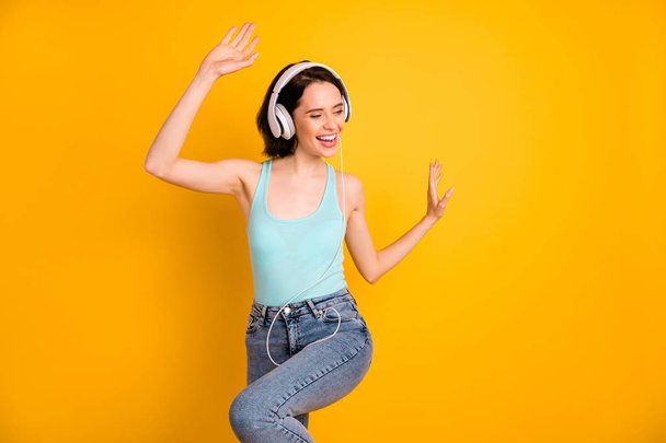 Photo of nice cute cheerful encouraged charming girlfriend feeling happy so dancing energetically while isolated with yellow background - Photo, Image