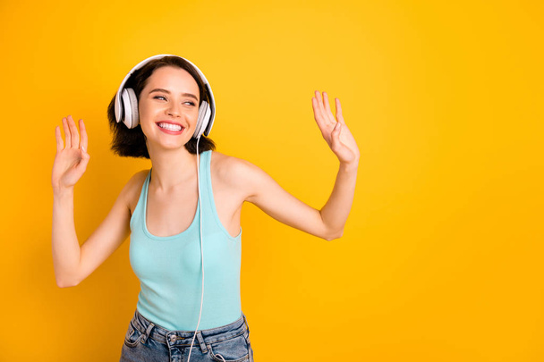 Photo of energetic nice cute amazing encouraged girlfriend dancing during her trip abroad while isolated with yellow background - Фото, изображение
