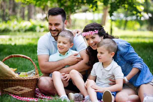 Happy family enjoying picnic with kids in nature - Fotografie, Obrázek