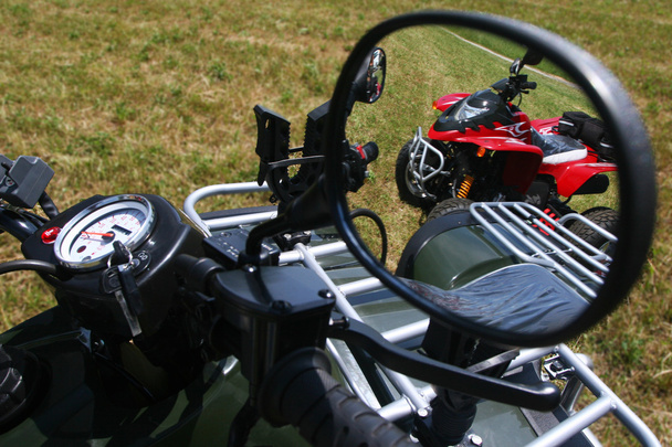 Red quad bike in rear view mirror - Фото, изображение