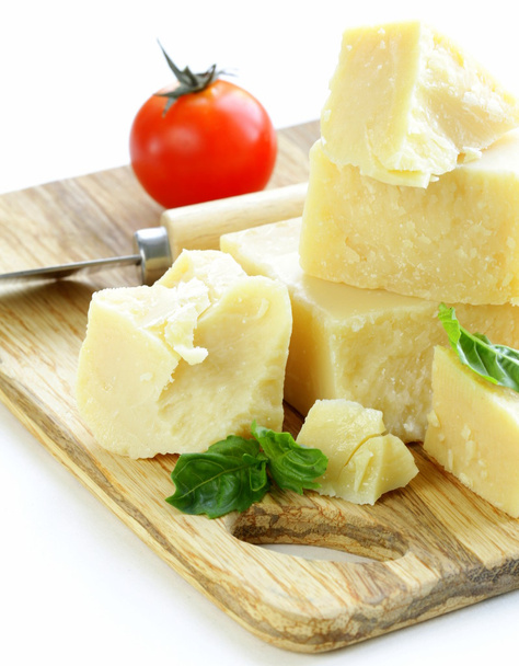 Hard natural parmesan cheese on a wooden board - Photo, Image